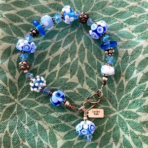 A charming SS hand blown glass beaded bracelet in light blue and white.